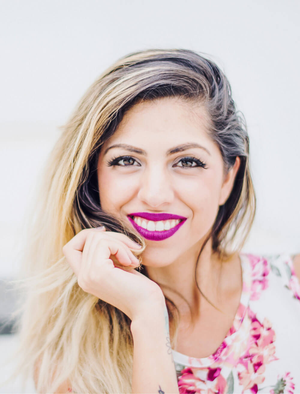 A woman smiling because she used botox for tmj near me .
